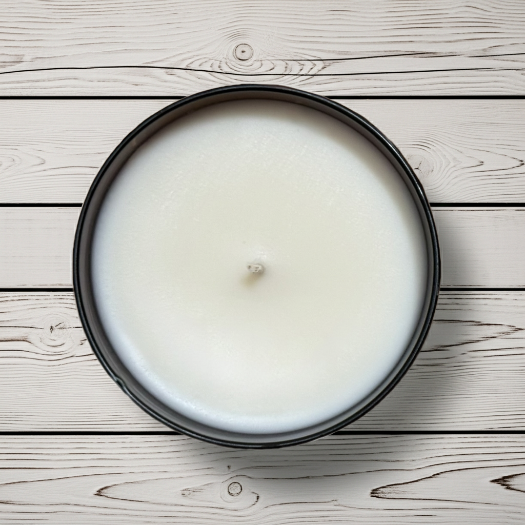 Stowick candles cinnamon woods White candle in a black container on a wooden surface