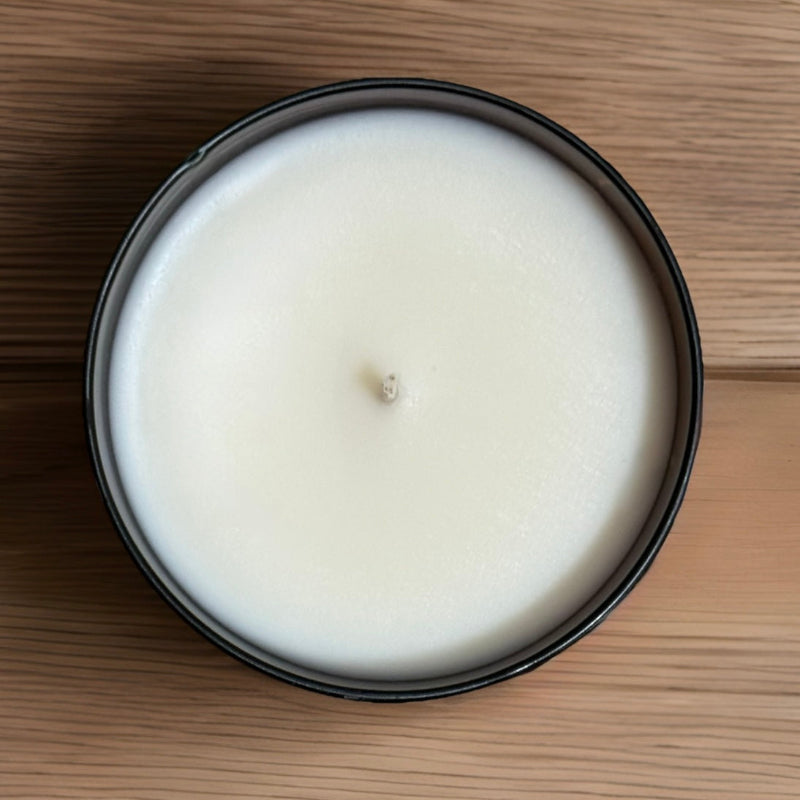 Pumpkin spice tumbler candle sitting on a wood table