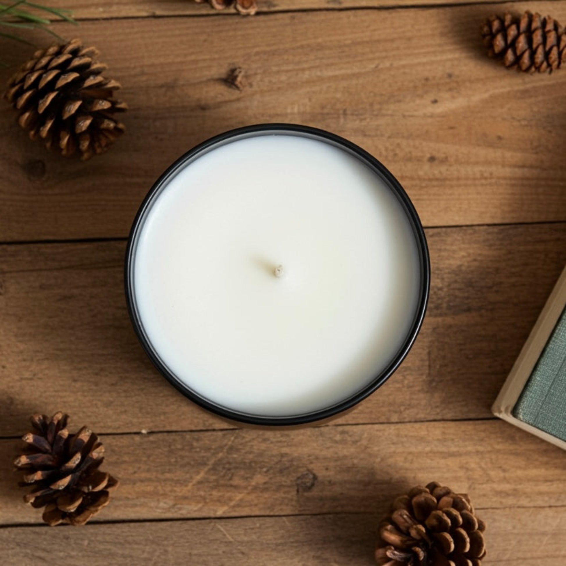 A spiced apple tumbler candle Birds Eye view on a wood table