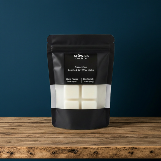 Stowick Candle Co. Campfire scented soy wax melts packaging on a wooden surface with a blue background