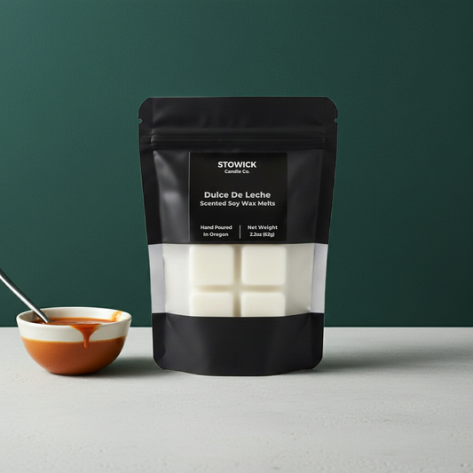 A bag of scented Dulce De Leche wax melts on a white surface with a green background.