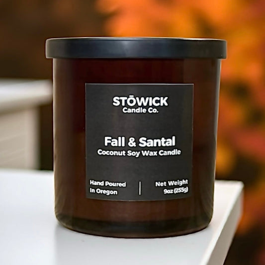 Stowick Candle Co. Fall and Santal tumbler candle on a white surface with a blurred background