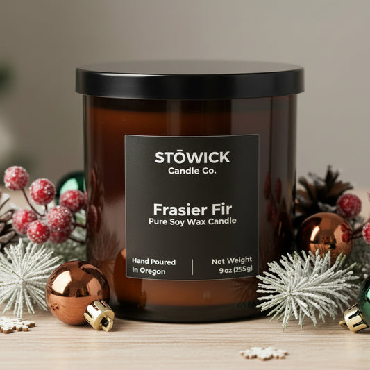 A Fraser fir scented tumbler candle with holiday decor 