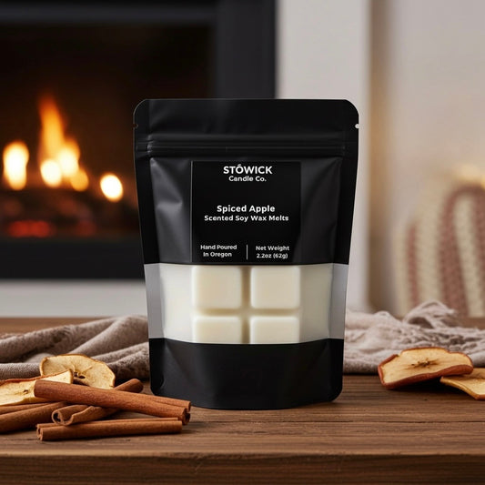 Stowick Candle Co. spiced apple scented soy wax melts packaging with cinnamon sticks and apples on a wooden surface.