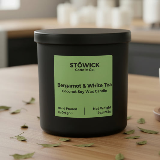 A bergamot and white tea tumbler candle on a kitchen counter