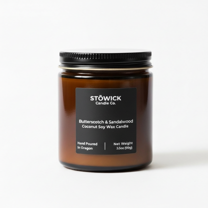 Stowick butterscotch sandalwood mini candle jar with a black lid and label on a white background