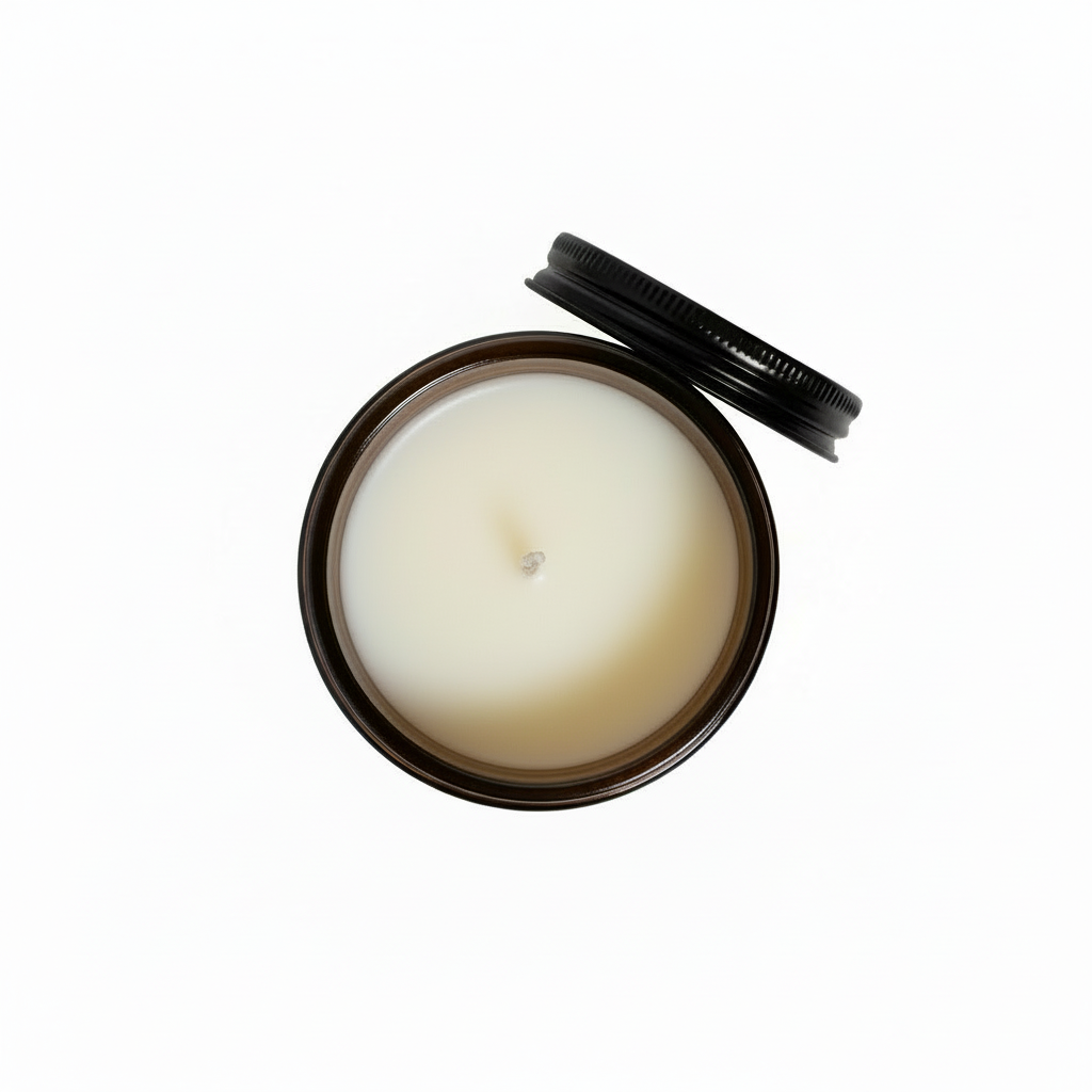 A Birds Eye view of a caramel pumpkin candle with white wax in an amber jar