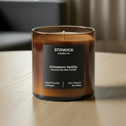 Stowick Candle Co. cinnamon vanilla tumbler candle on a wood table in an amber jar