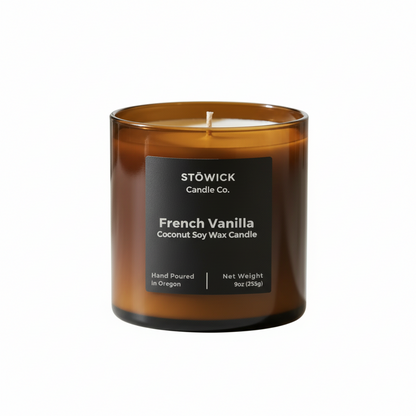 A French vanilla tumbler candle in an amber jar by Stowick candles on a white background 