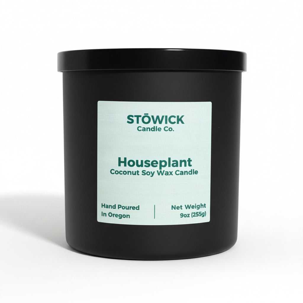 A houseplant scented tumbler candle in a jack jar with a black lid on a white background