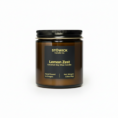 Stowick Candle Co. Lemon Zest candle in amber jar with black lid on a white background