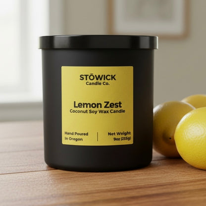 Stowick Candle Co. Lemon Zest candle on a wooden surface with lemons in the background