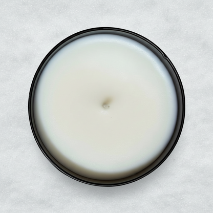 Mt hood tumbler candle in a black container in the snow