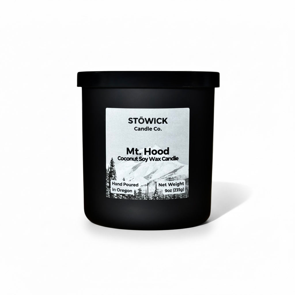 A Mt. Hood Tumbler candle in a Black jar against a white background