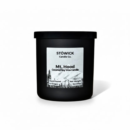 A Mt. Hood Tumbler candle in a Black jar against a white background