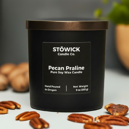 A 9 ounce pecan praline scented soy wax candle in a black jar with a bronze lid