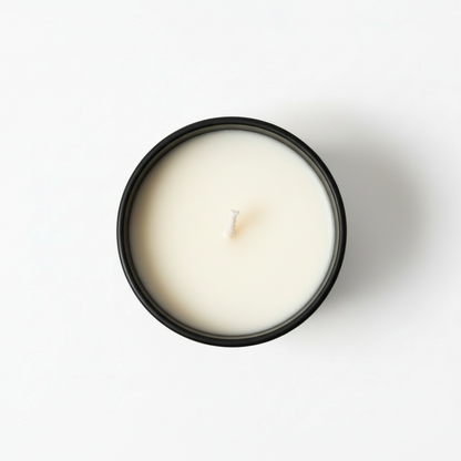 A pecan praline tumbler candle view from above in a black jar with a white background
