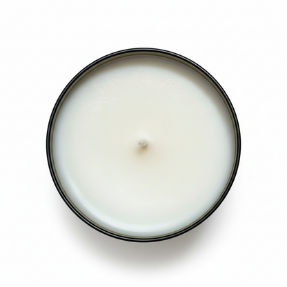 A white Portland tumbler candle in an amber jar from above with a white background 