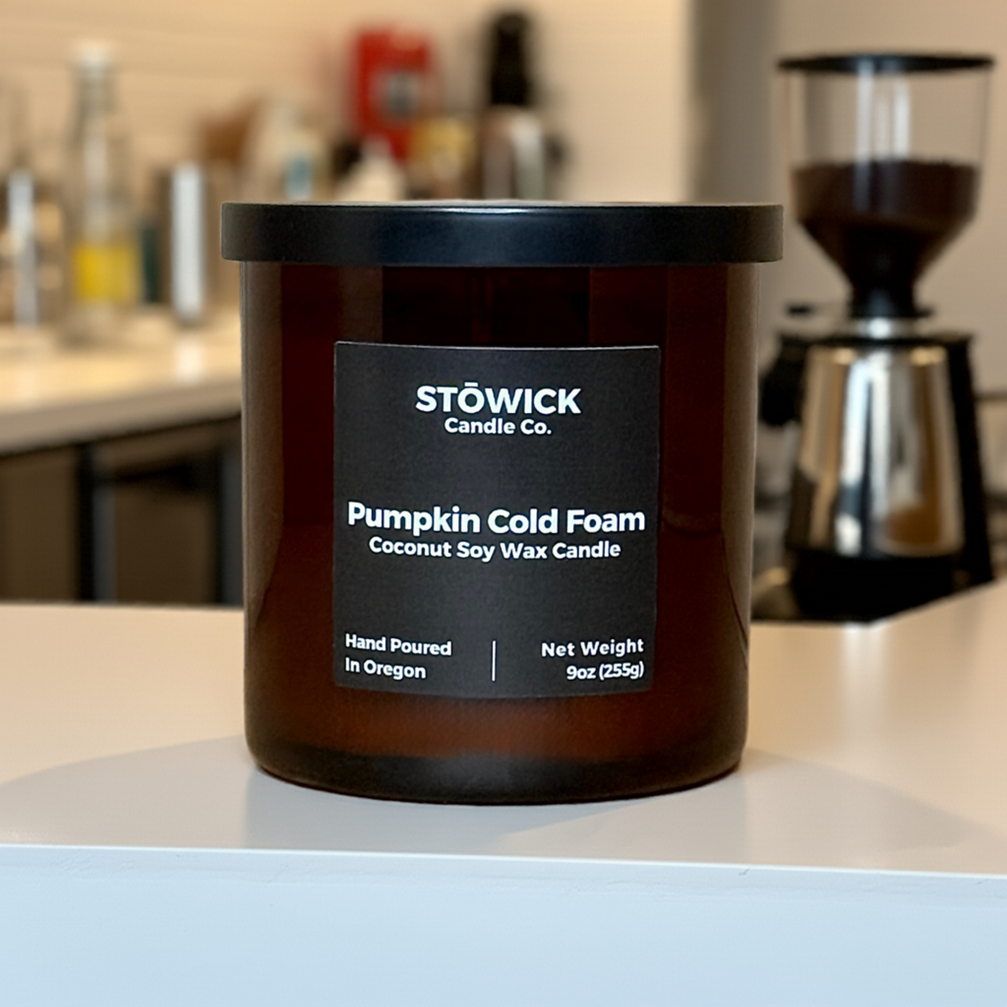 A Pumpkin Cold Foam Tumbler Candle sitting on a cafe table