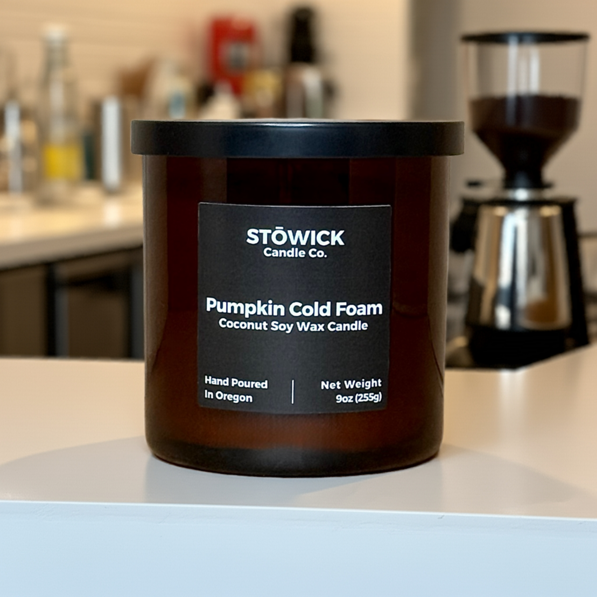 A Pumpkin Cold Foam Tumbler Candle sitting on a cafe table