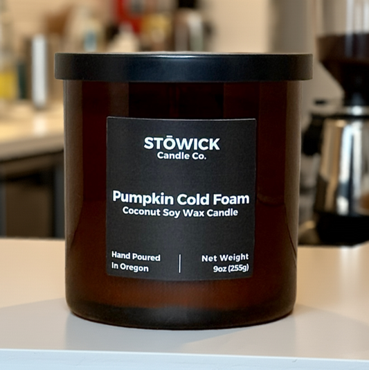 Stöwick Candle Co. pumpkin cold foam candle on a surface with a blurred background