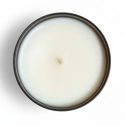 A pumpkin spice tumbler candle from above with a white background 