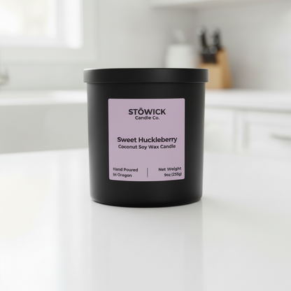 Stowick Candle Co. Sweet Huckleberry candle on a white surface with a neutral background