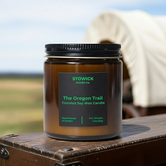 Stowick Candle Co. The Oregon Trail mini candle on a wooden surface with a blurred natural background